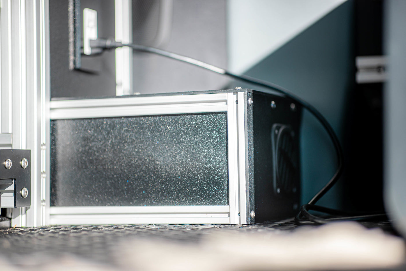 Detailed view of a custom-built enclosure with aluminum framing, likely for a power system, inside an RV rental.