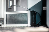Detailed view of a custom-built enclosure with aluminum framing, likely for a power system, inside an RV rental.