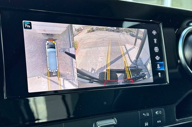RV rental's 360-degree camera display for parking assist. Split screen shows overhead virtual view and rear camera.
