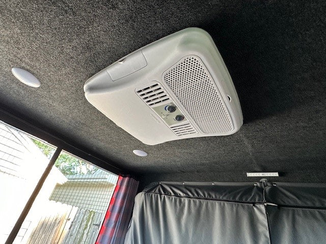  and power panel for easy camping.|An inviting RV rental interior featuring a rolled bed — photo 10