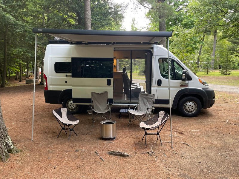 RV rental camper van with awning, chairs, and Solo Stove fire pit set up at a forest campsite. Perfect for outdoor adventures. — photo 2