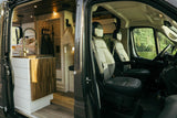 Inside a spacious rv rental camper van: modern kitchen, bath, and bed. Front seats overlook a scenic lake view, ready for adventure.