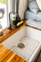 Modern RV rental kitchen: sleek sink, butcher block, and eco-friendly soaps for compact living.