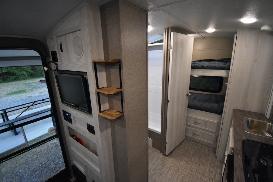 RV rental interior: organized layout with bunk beds, modern kitchen, bathroom, and entertainment options. — photo 20