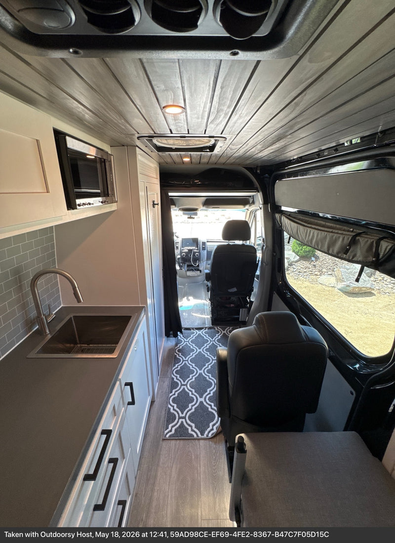  and cozy bench seating.|Inside a modern rv rental camper van — photo 4