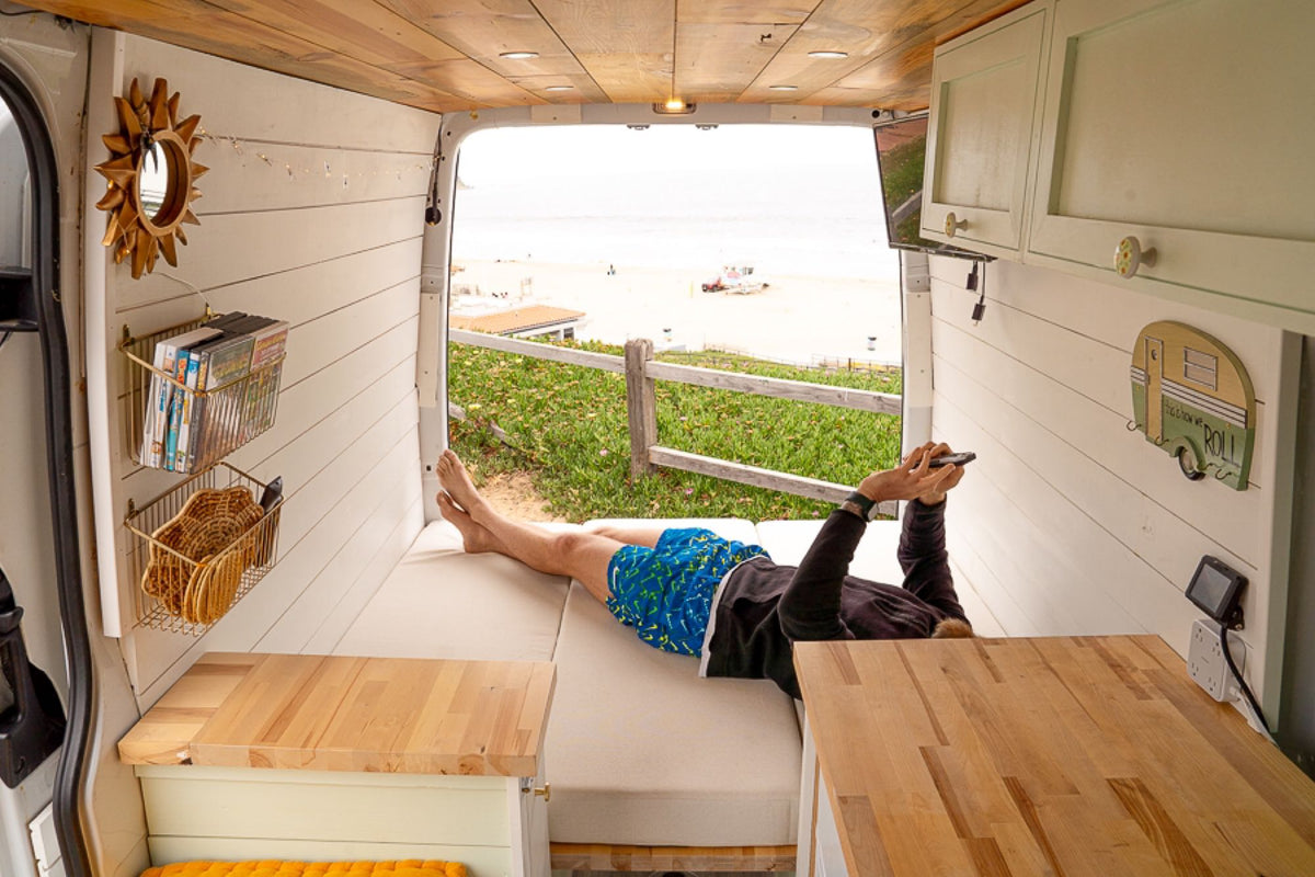  fully-equipped van kitchen.|Stylish **RV rental** van conversion interior showing a cozy dining area — photo 5