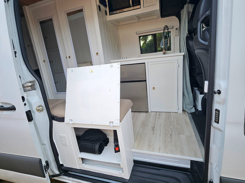  looking toward the rear doors. A window is on the left wall.|RV rental: A brightly lit camper van interior with wood ceiling — photo 14