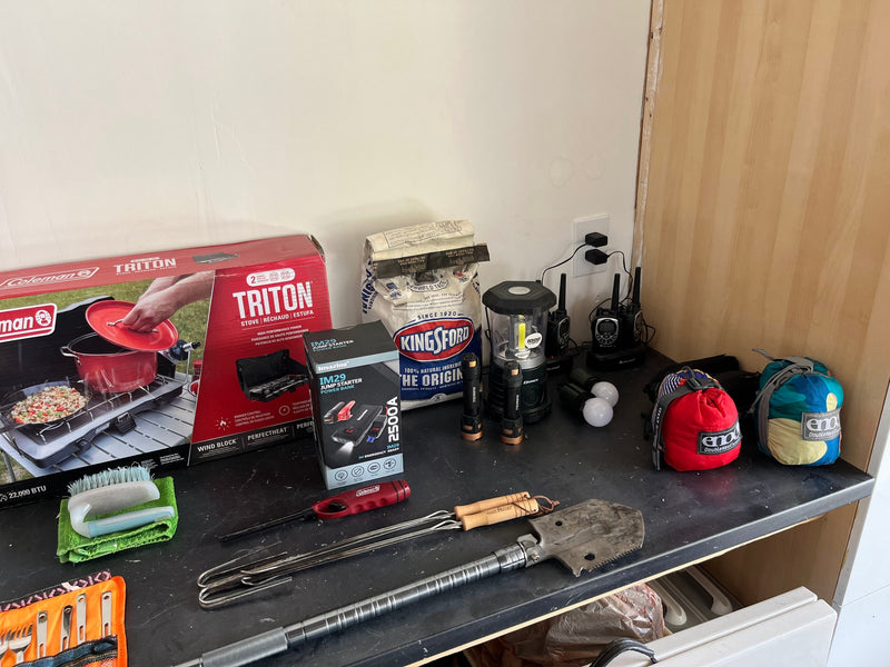 RV rental essentials: Coleman stove, hammocks, charcoal, and emergency gear for your outdoor adventures. — photo 17