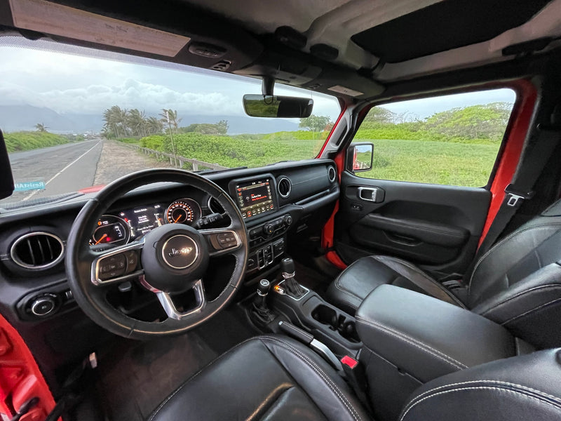 Inside a modern Jeep looking out at a scenic coastal road and mountains. Ideal for an adventurous rv rental trip. — photo 6