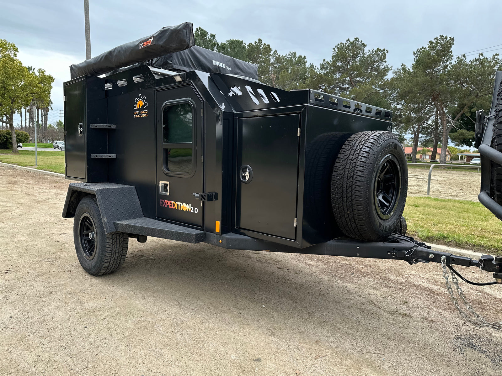Adventure-ready Expedition 2.0 off-road camping trailer, a rugged RV rental alternative. Features rooftop tent and awning.
