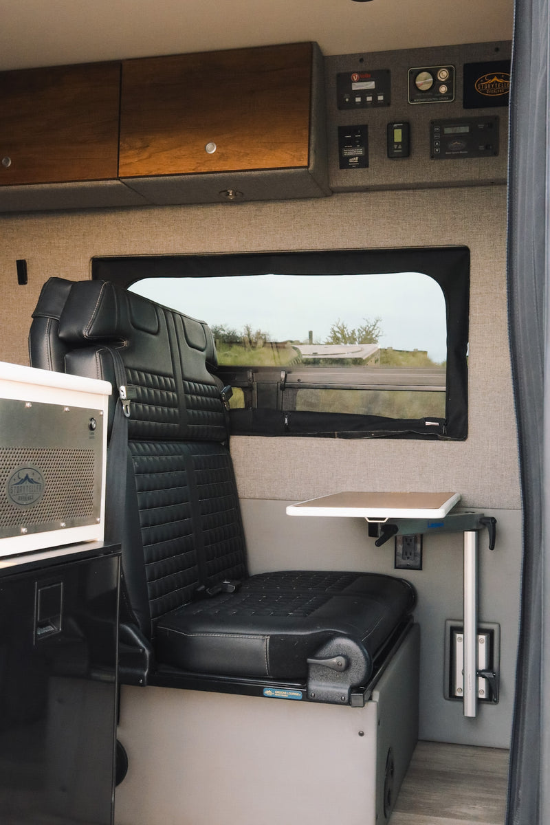  and infotainment screen. Ready for your road trip!|Inside an RV rental campervan: open doors show the driver's cabin and a customized living area with bench seating and controls.|Inside your next RV rental: comfy dinette seating — photo 3
