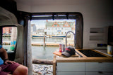 Experience coastal living in an RV rental: scenic harbor views, a fully equipped kitchen, and comfy seating.