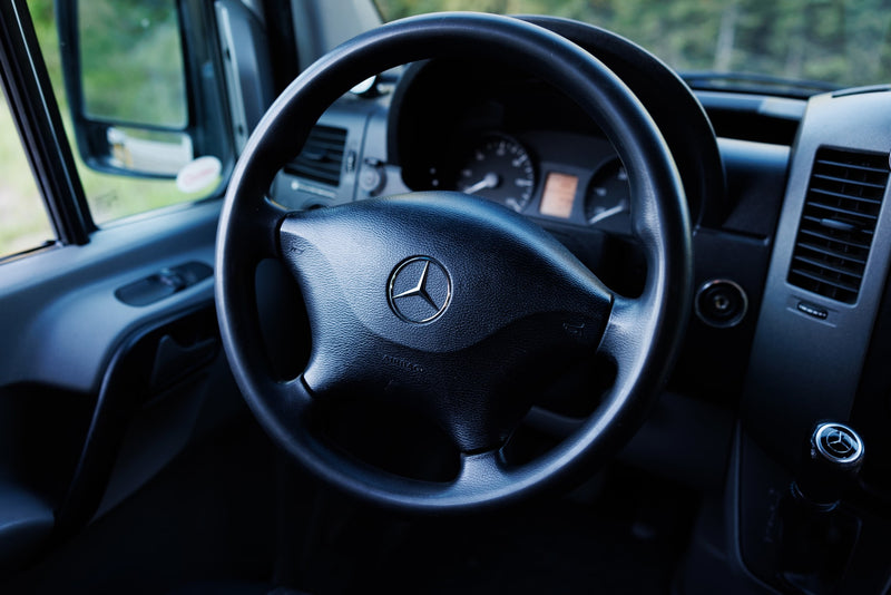 Mercedes-Benz RV rental interior, featuring the steering wheel, dashboard, and door panel, ready for adventure. — photo 11