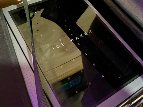 This sleek ice maker, labeled 'ICE MAKER,' ensures cold drinks for your RV rental adventures. Essential for travel comfort.