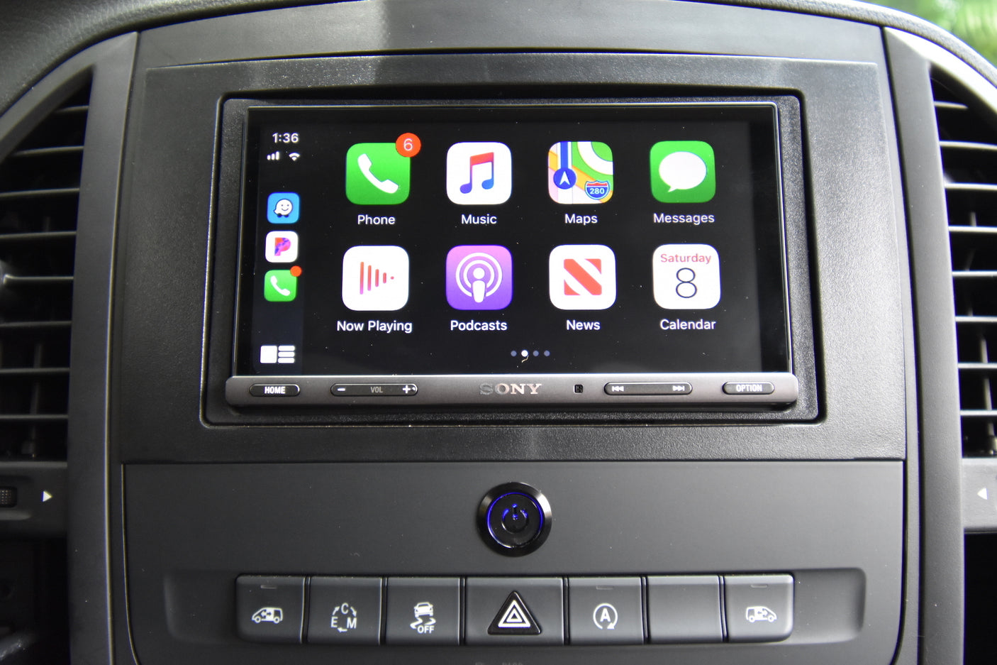 An RV rental car's dashboard shows a Sony infotainment display running Apple CarPlay with icons for Phone (6 alerts), Maps, and Music.