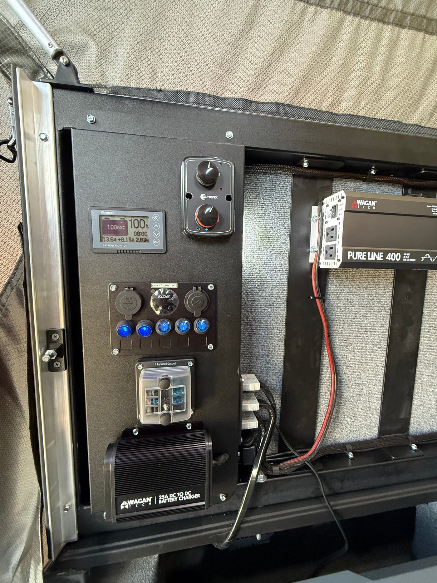 RV rental's integrated electrical panel, showing battery monitor, inverter, and charger for essential mobile power. — photo 10