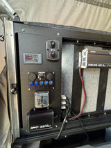 RV rental's integrated electrical panel, showing battery monitor, inverter, and charger for essential mobile power.