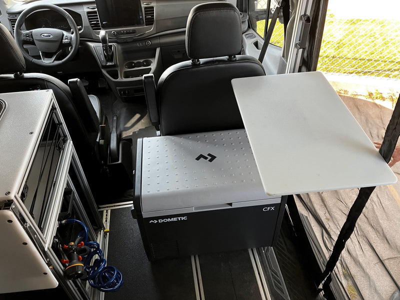 RV rental camper van interior showing a Dometic CFX fridge with attached portable table and water system. — photo 16