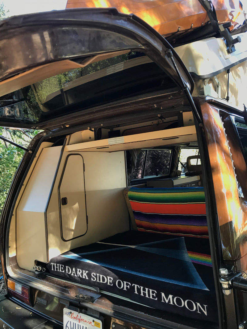 and warm wooden floor.|Inside this RV rental: a vibrant striped blanket on a bench — photo 15