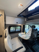 Relax in this RV rental's inviting dining area, complete with comfortable seating & scenic views outside.