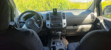 Nissan SUV interior: dashboard, steering wheel, & automatic shifter. Ideal for a nature road trip or supporting an RV rental adventure.
