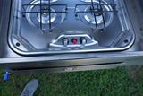 A compact, two-burner stainless steel gas stove with ignition and control knobs, perfect for cooking in this RV rental.