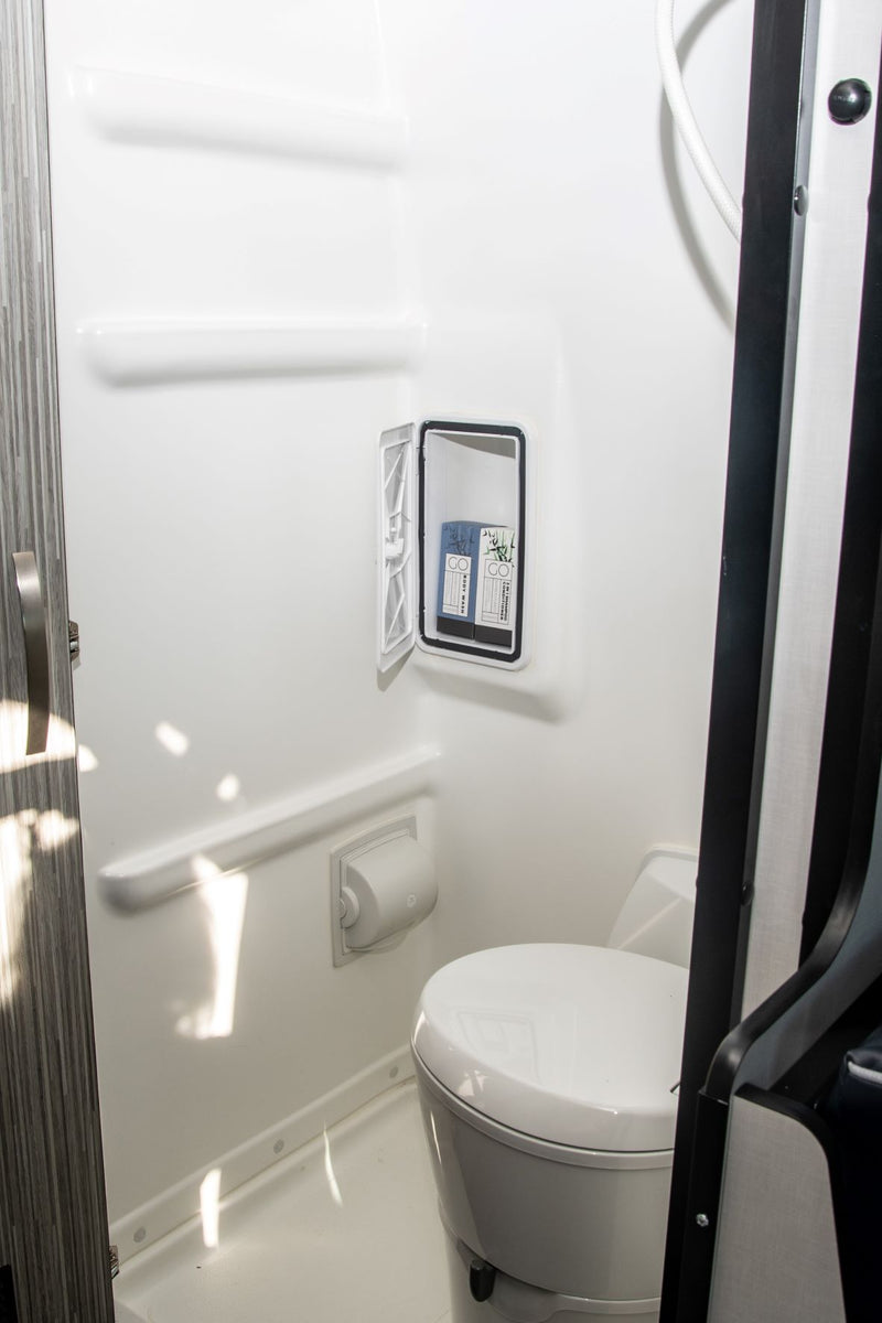  city lights in distance.|Discover winter with an rv rental! A gray camper van sits on asphalt beside a frozen lake & snow-covered mountains.|Dark gray RV rental camper van — photo 9