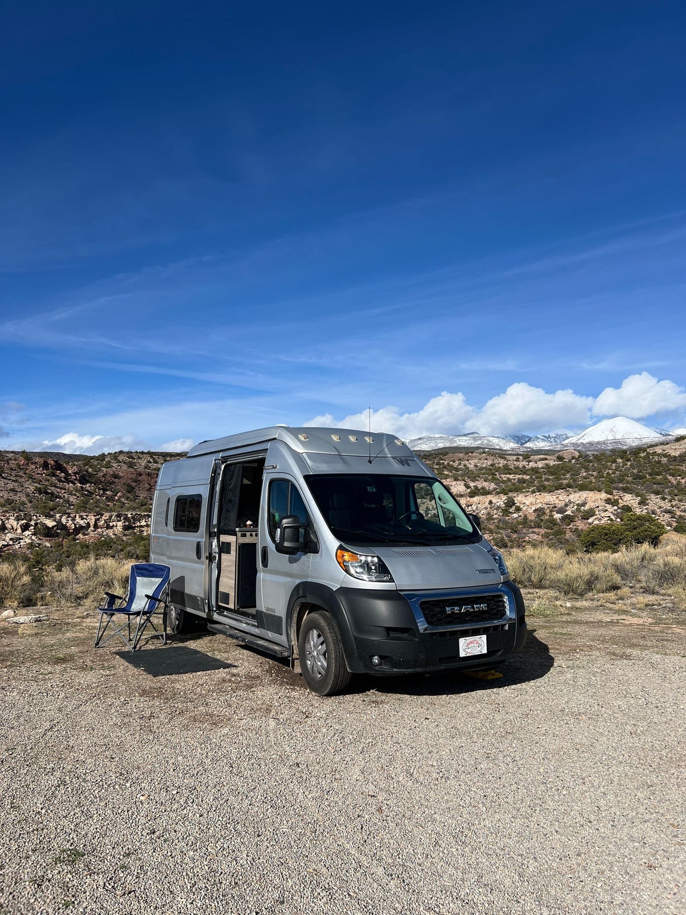  with golden light from low sun behind trees & frosted grass.|Silver Winnebago Solis camper van with pop-top roof extended — photo 3