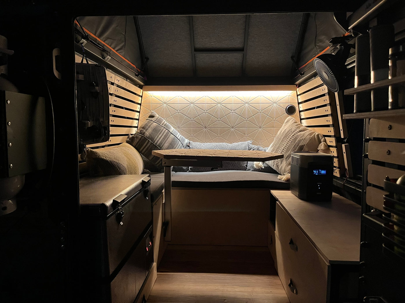 Cozy RV rental interior with comfy seating, ambient lighting, and storage. Perfect for travel! — photo 4
