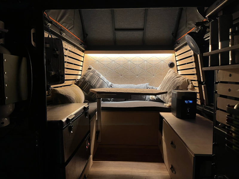 Cozy RV rental interior with comfy seating, ambient lighting, and storage. Perfect for travel! — photo 4