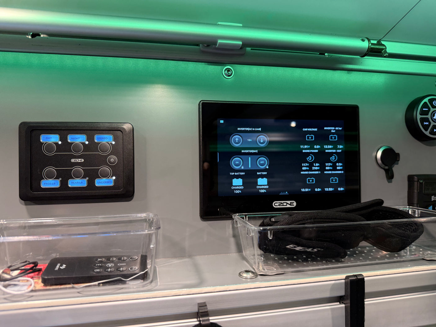 RV rental interior controls: CZone digital power management screen, light switches, Dometic remote.