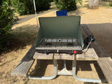 An optional green Coleman propane camp stove with an attached propane tank available at no charge.
