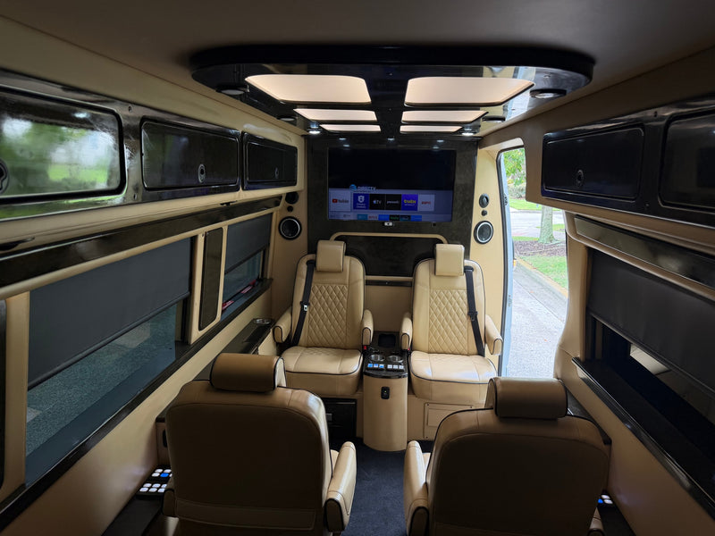 Experience luxury in this RV rental's spacious interior: tan captain's chairs, large TV with streaming apps, and custom ceiling lights. — photo 12
