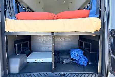  and front seats.|Spacious RV rental camper van interior with a comfy bed — photo 3