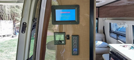 RV rental interior: Winnebago smart control panel, Truma thermostat, and light switches offer modern mobile living.