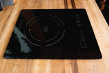 This True Induction cooktop on a wooden counter is perfect for an RV rental kitchen, ideal for compact cooking.