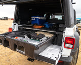 Jeep Gladiator truck bed with DECKED storage drawers, cooler, and power station, ideal for organized overlanding or rv rental.