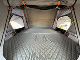 Spacious Roofnest rooftop tent interior, offering a comfortable sleep on quilted mattress. Great RV rental alternative.
