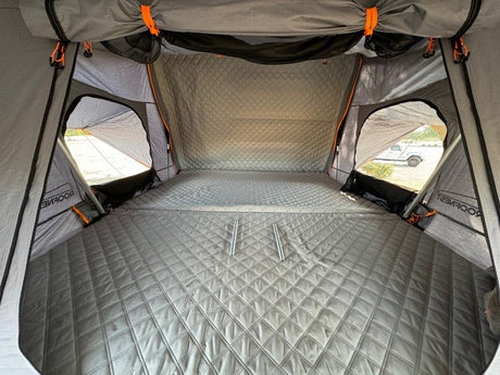 Spacious Roofnest rooftop tent interior, offering a comfortable sleep on quilted mattress. Great RV rental alternative.