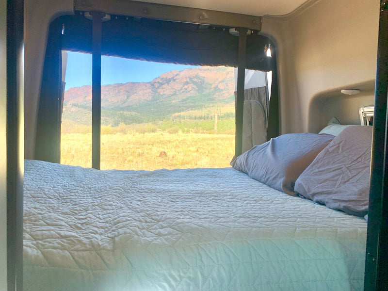  parked in a grassy mountain landscape under a bright — photo 3