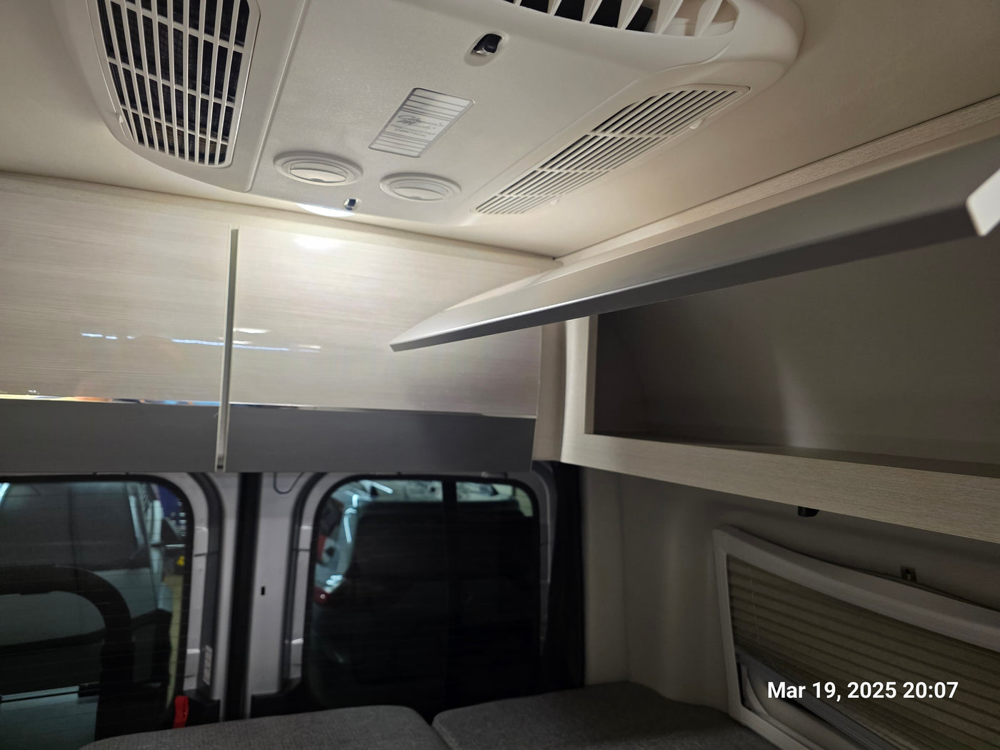  doors open for desert camping. Experience van life travel adventures!|Modern RV rental interior featuring overhead AC vents — photo 7