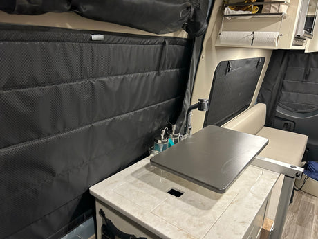 Cozy RV rental interior with kitchen sink, durable window covers, and seating area, designed for compact travel.