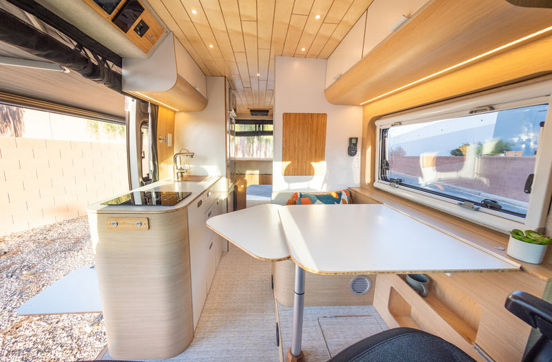  and a pull-out table.|RV rental: Open side of a modern camper van with extended awning — photo 7