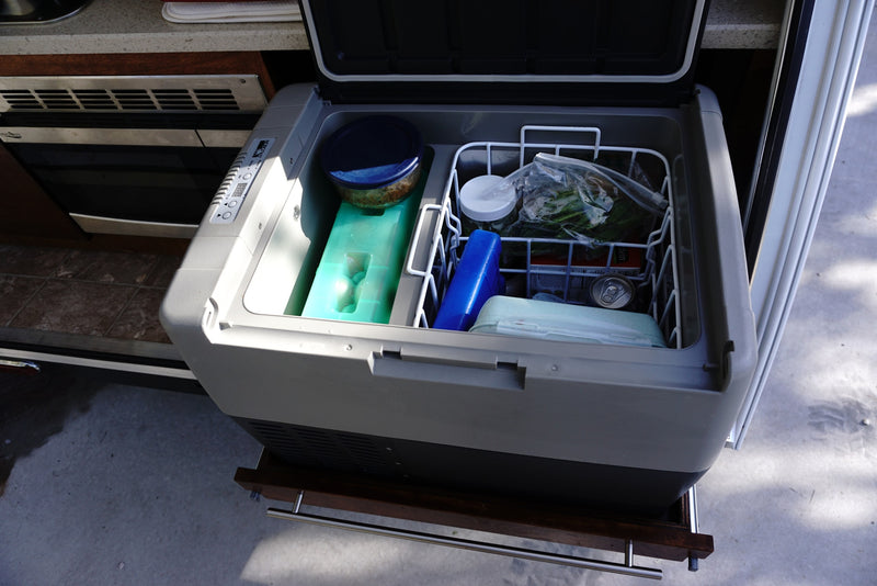Open portable fridge in an RV rental, stocked with food, ice packs & drinks for comfortable travel. — photo 3