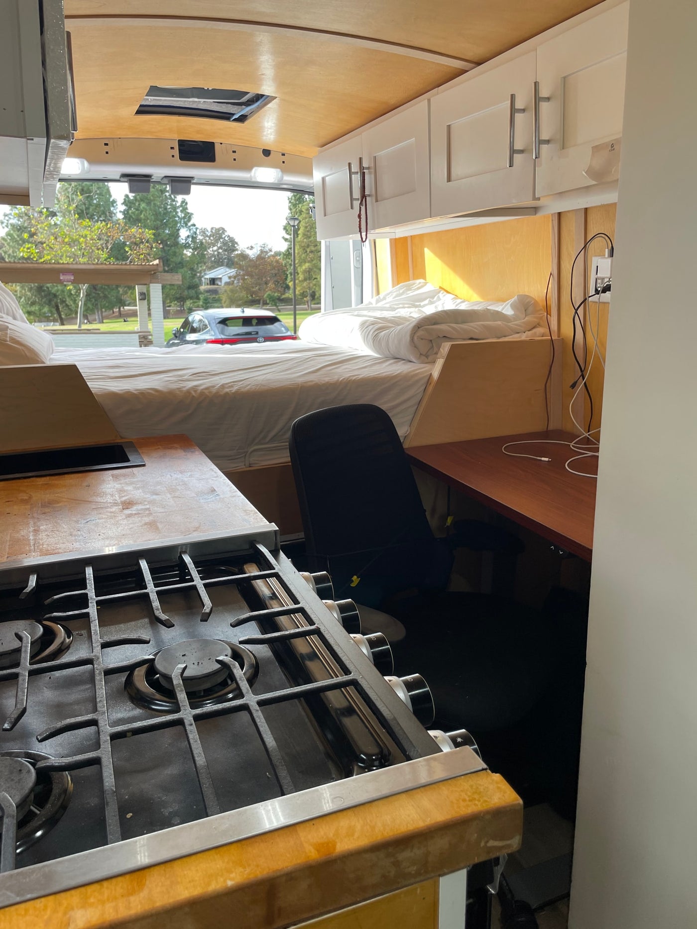  cozy rv rental interior.|Interior of a modern camper van kitchen with stove — photo 7
