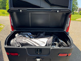 Open RV rental cargo box storing golf bags & clubs, ready for your next golf trip.