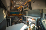Cozy & fully-equipped rv rental interior with bed, kitchen, storage, and power system for comfortable travels.