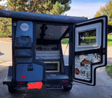  perfect for forest camping adventures.|RV rental interior: cozy gray seating/bed