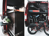 Explore with an RV rental: Van interior with sink, helmets, & spacious rear storage for bikes. Ready for winter adventures!