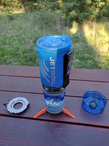 Jetboil camping stove on a picnic table. Essential for outdoor cooking during an RV rental trip.